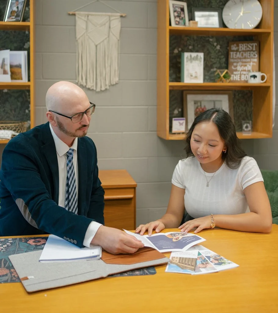 A student reviews written guidance with an adviser.