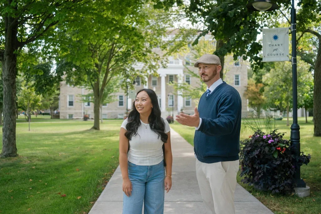 A student talks with an adult during a campus visit.