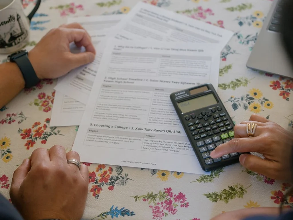 Family members review documents with a calculator.